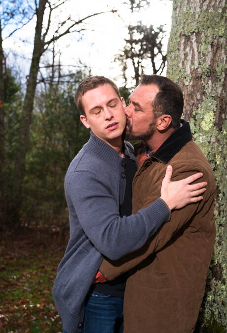 Mature Nick Capra posing with hot young gays outdoors